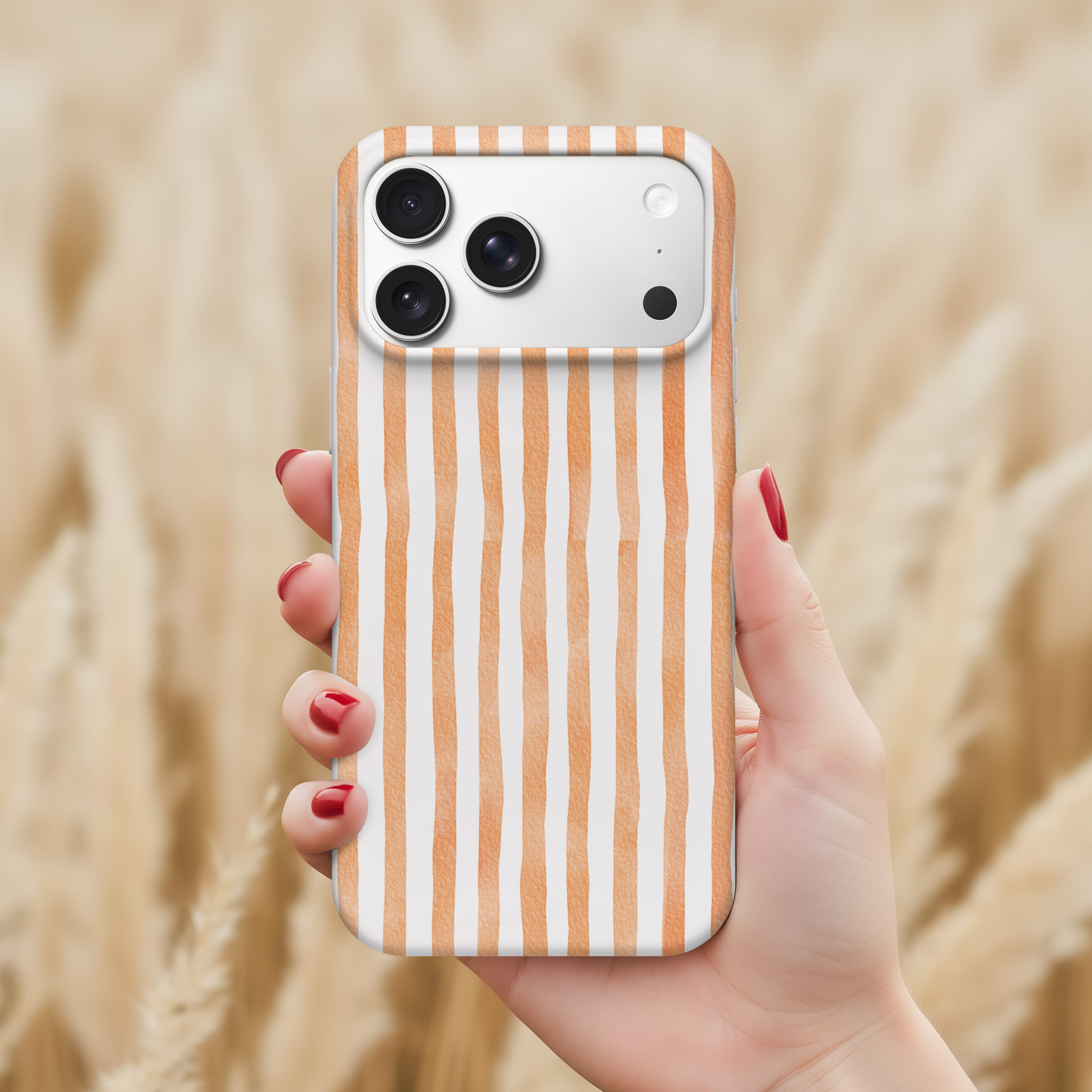 A hand holding a smartphone with a striped pattern on the back cover.