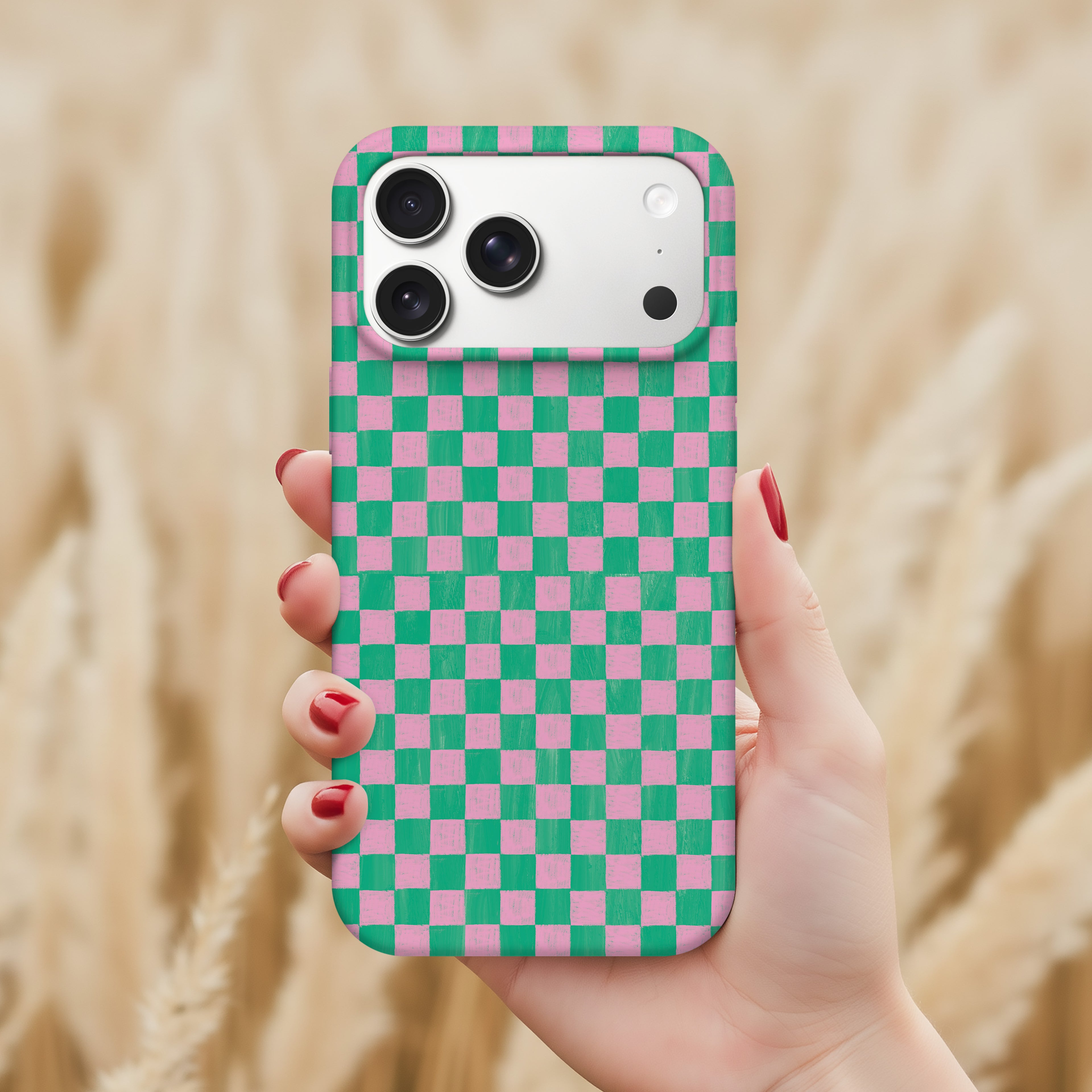 A hand holding a phone with a colorful checkered pattern on the back cover.