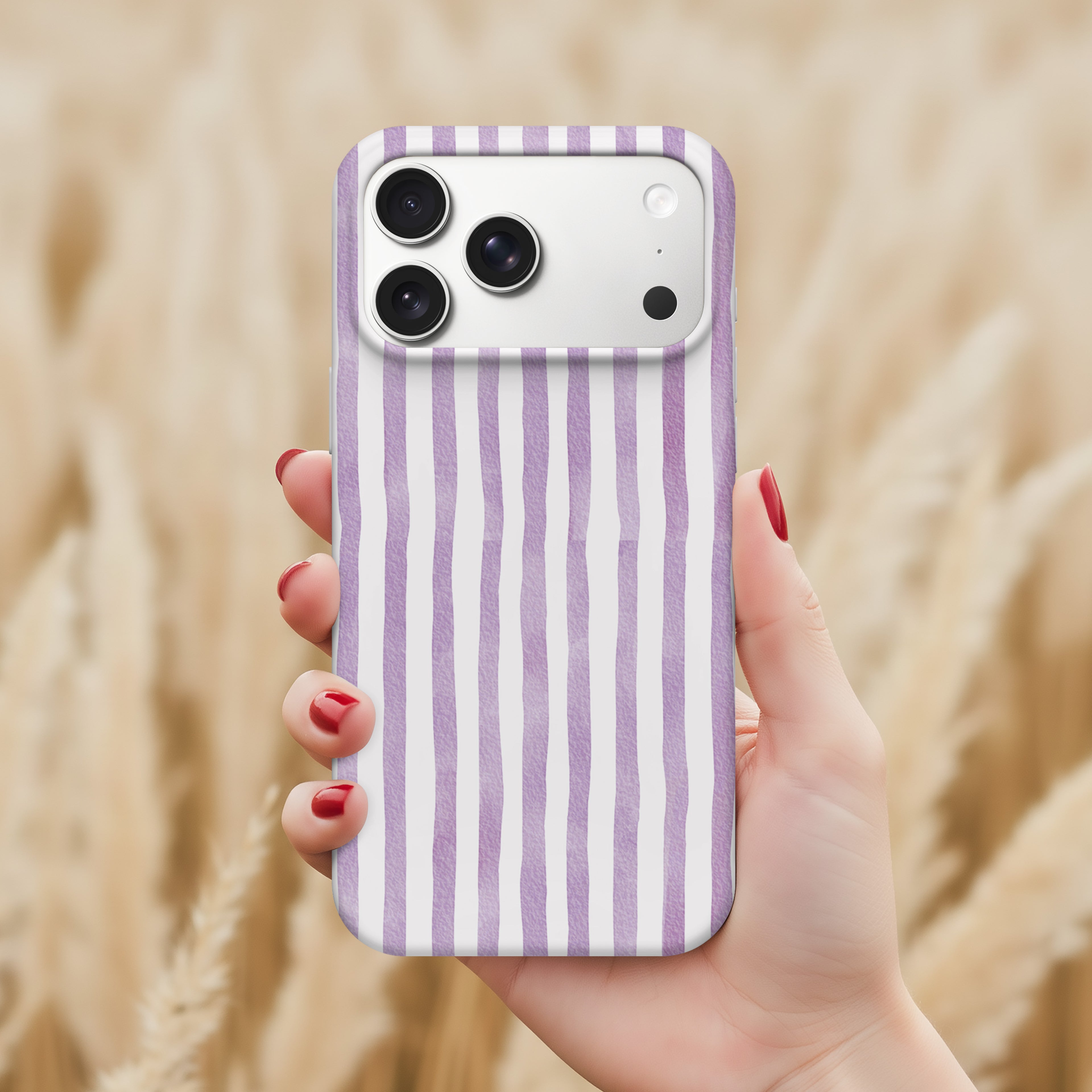 A hand holding a purple and white striped phone case with a camera on the back.