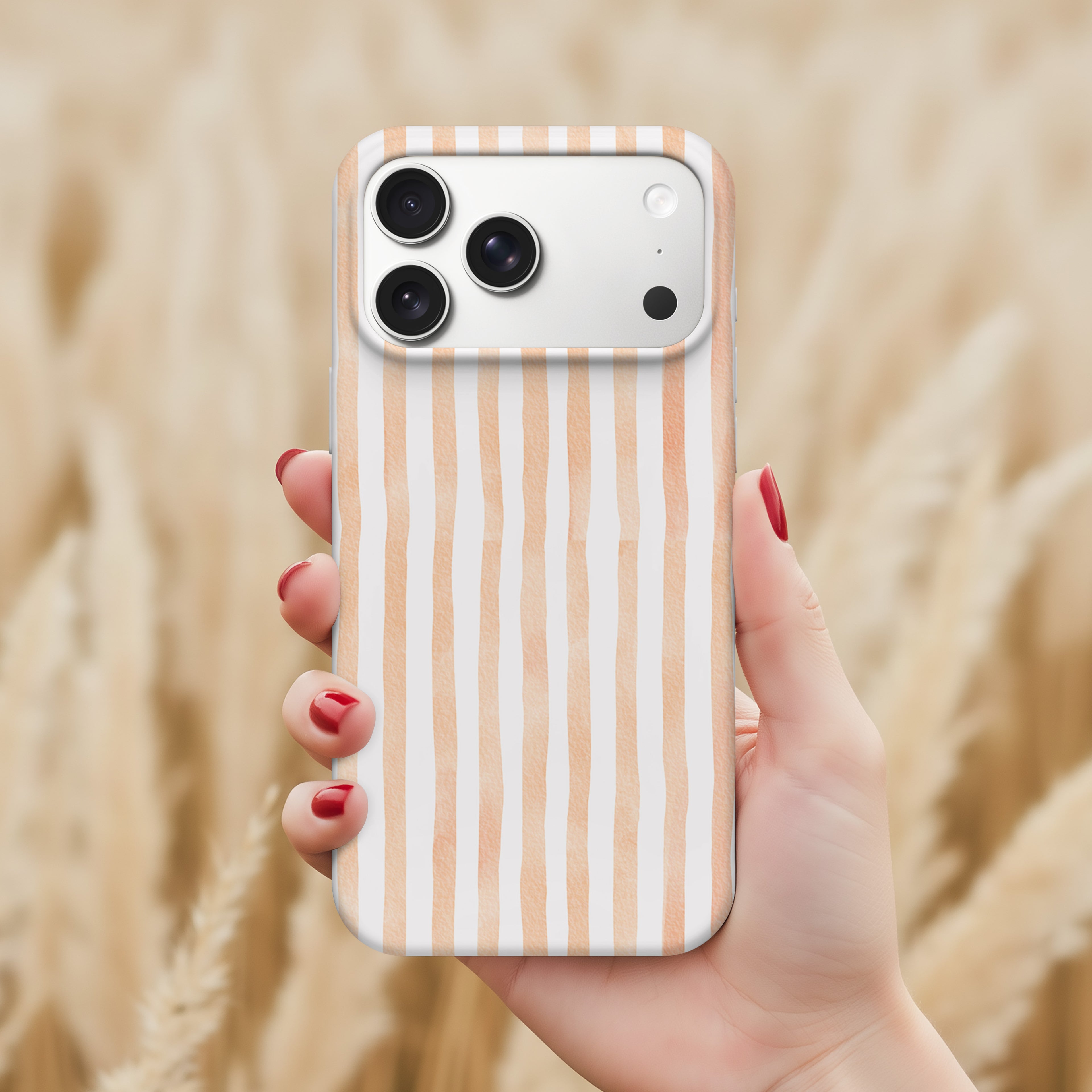 A hand holding a smartphone with a striped pattern on the back cover.